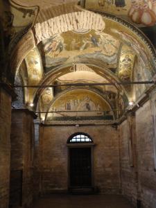 Horizontal view: plain stone walls, gilded vaults with mosaics above