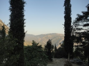 View of far mountain between cypresses