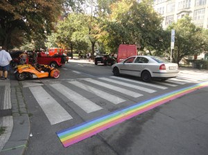 Street with rainbow stripes along zebra crossing