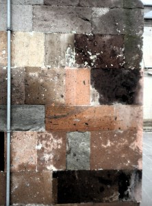 An irregular grid of rectangular stones of various colors