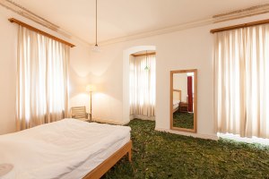 Fig leaves cover the floor of a hotel room