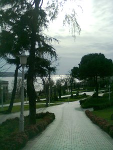 Walkway down to a formal garden, and beyond it the sea