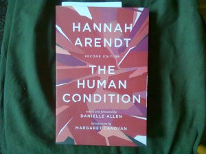 Red-themed cover of The Human Condition against dull green cloth