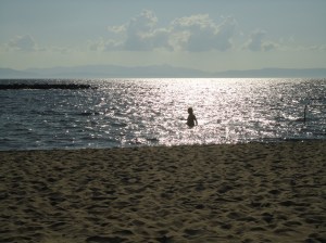 Human figure in silhouette against a shining sea