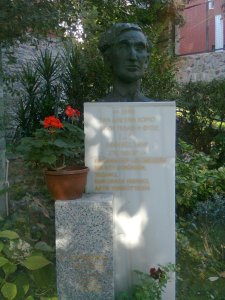 The bust of Cavafy with inscription and potted geraniums