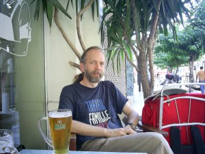 Glass with the label of Mythos Beer