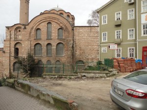 On the side of the old church is a 3×3 array of windows, each with semicircular arch; above them all, another such arch
