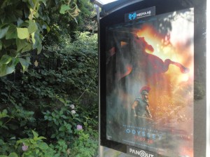 Next to foliage, a poster advertises the Odyssey film